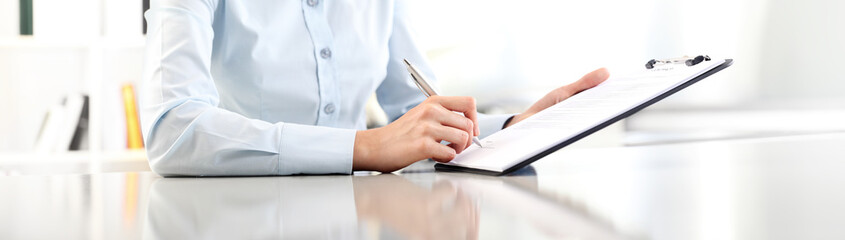 woman hands writing on clipboard with a pen, isolated on desk panoramic