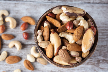 Healthy mix nuts on wooden background. Almonds, hazelnuts, cashews, peanuts, brazilian nuts