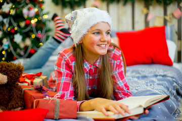 happy child girl with Christmas gifts