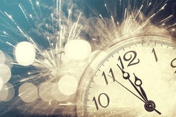 Abstract background with fireworks and clock close to midnight