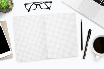 Blank grid lines notebook page on white desk. Top view, flat lay.