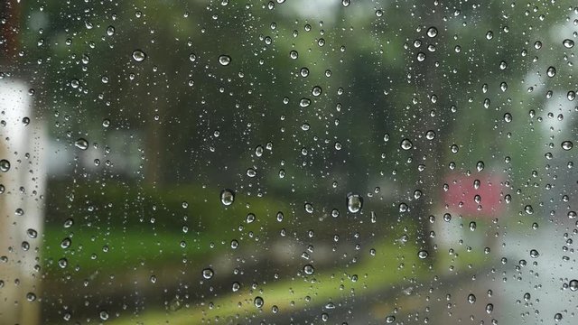 Rain drops on windows Focus on rain drops down the window in rainy day