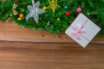 Christmas gift boxes and fir tree branch on wooden table. Top view with copy space