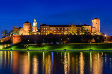 Naklejka na ściany i meble A night view of Wawel castle located on bank of Vistula river in Krakow city, Poland.