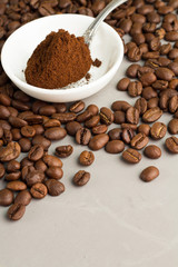 ground coffee, coffee beans and gray background