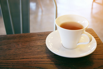 Closeup of cup of tea on vintage wooden background and vintage tone