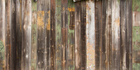 Texture wooden fence with horizontal yellow boards and faded pai