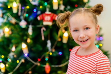 Little girl decorating Christmas tree