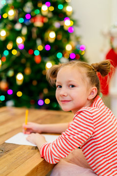 Little girl writing mail to Santa