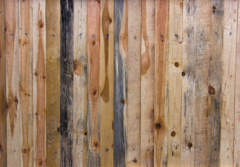 Texture wooden fence with horizontal yellow boards and faded pai