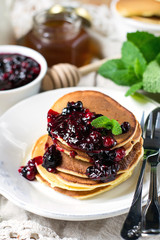 Homemade pancakes with berry sauce coulis and mint