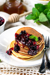 Homemade pancakes with berry sauce coulis and mint