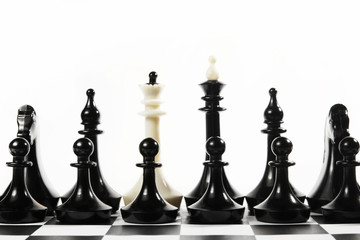 White queen in the set of black chess pieces. Concept of betrayal and treason