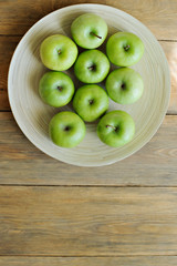 Green apples on wooden background, top view, copy space, place for text.