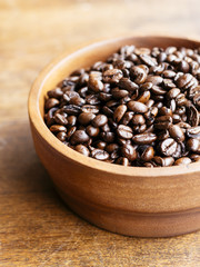 Organic coffee beans in a wooden bowl