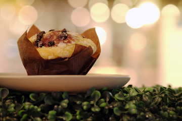 blueberry muffin and bokeh Scene in bakery shop warm tone background
