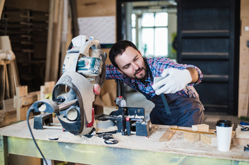 Carpenter taking a selfie with miter saw at his work place