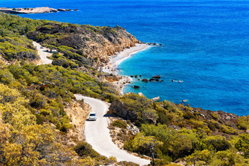 Fototapeta na wymiar top view of lagoon island Rhodes, with a winding road and the car on it