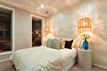 Side view of a luxurious bedroom with a king size bed and a swir