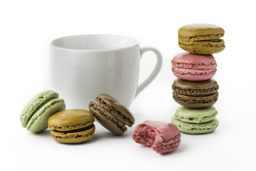 Sweet and colourful french macaroons or macaron on white background with a cup of coffee