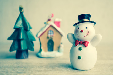 Snowman with vintage filter, On wooden table.