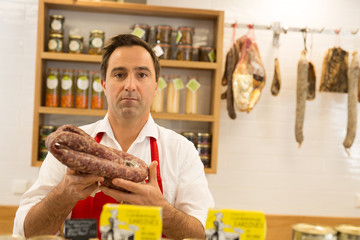 butcher with french dry sausage