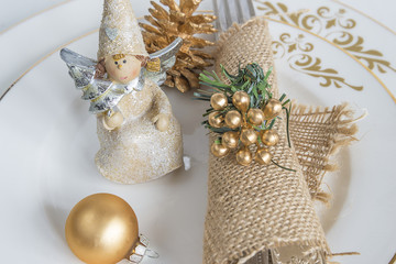 Beautifully decorated white plates for christmas dinner