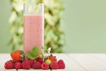 smoothie of berries on the table in the garden