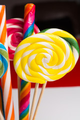 Multicolored sweet candy canes and twirls on wooden sticks