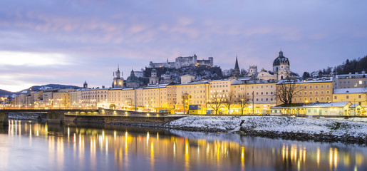 Fototapeta na wymiar reflections in water of golden lights in European city in winter day