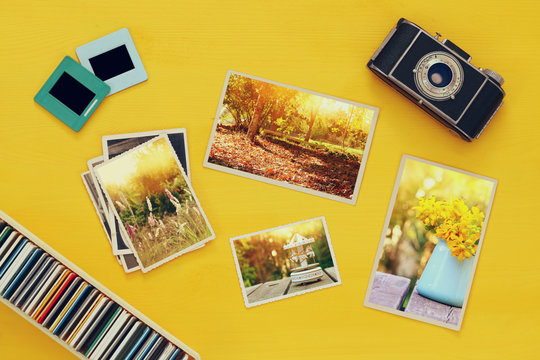 Top view of photographs next to old camera