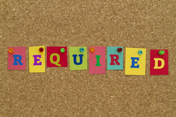 Required word written on colorful sticky notes pinned on cork board.