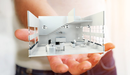 Businessman holding white 3D rendering apartment in his hand