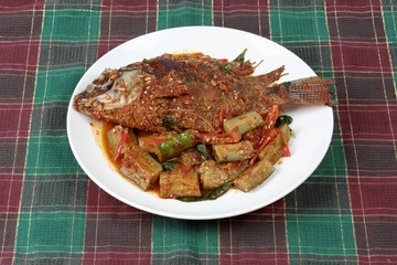 Deep-fried tilapia fish topped Spicy fried eggplant.