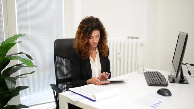 Woman using a tablet in her office.
