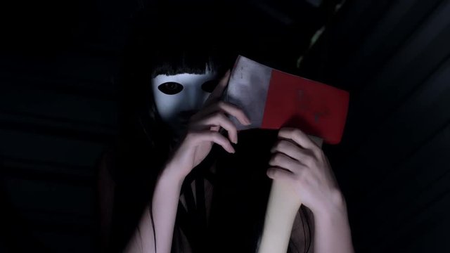 4k Shot of a Scary Woman with Mask and Axe (reverse)