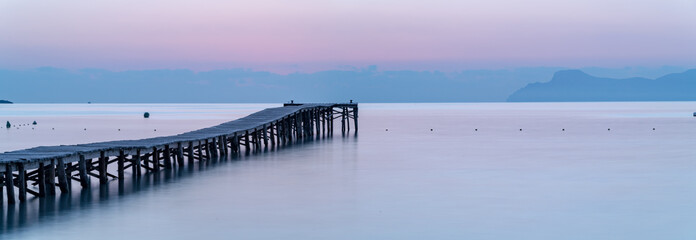 Fototapeta na wymiar Sunset on the beach with a pier