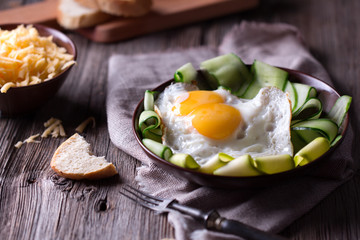 fried egg and bread on wooden table