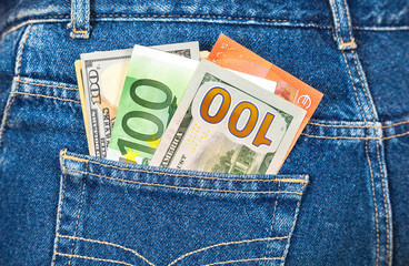 Euro and american currency, money in jeans pocket for travel and