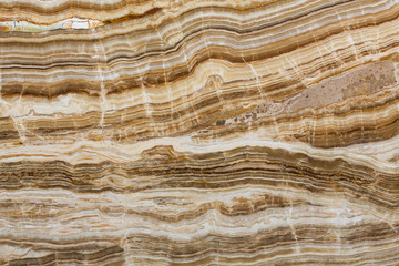 Onyx texture of natural stone, brown background.