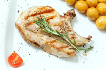 Bone steak decorated with a sprig of rosemary.