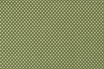 Fototapeta premium White polka dots on green fabric.