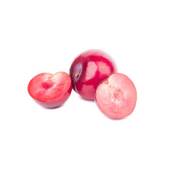 Heap of raw violet plums, isolated