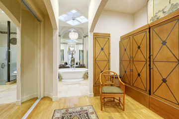 High ceiling room with mirror doors closet and brown wardrobes