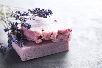 Lavender flowers and soap on grey table