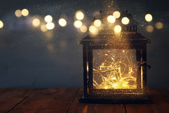 low key image of fairy lights inside old lantern
