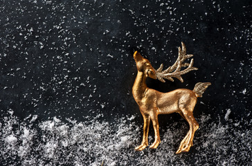 Golden deer and snow. Christmas background.