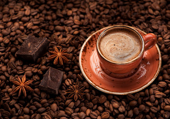 Cup coffee, chocolate and spice. background coffee beans..