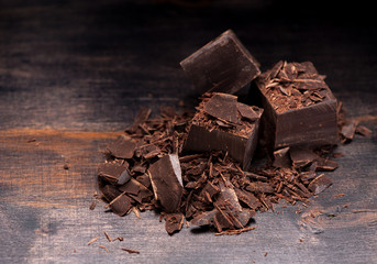 Dark chocolate on rustic background and space for text