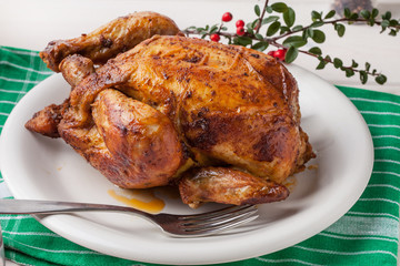 Baked chicken on white plate.